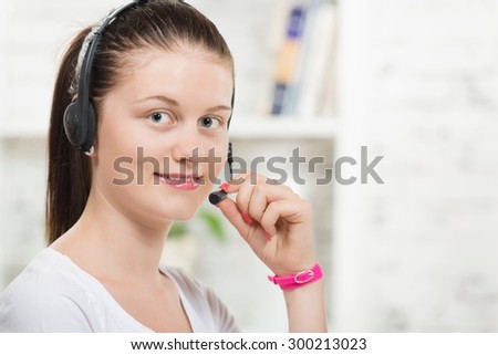 Pretty young smiling woman with a headset