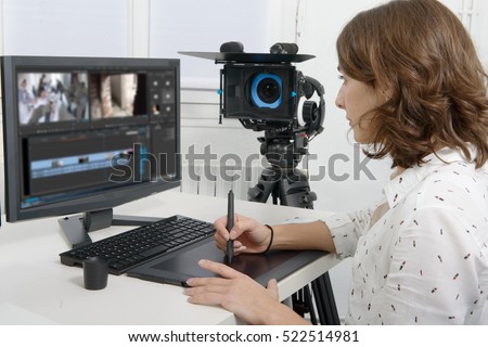 young female designer using graphics tablet for video editing