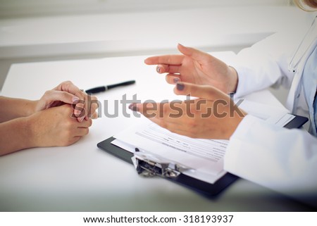 Doctor and patient are discussing something, just hands at the table