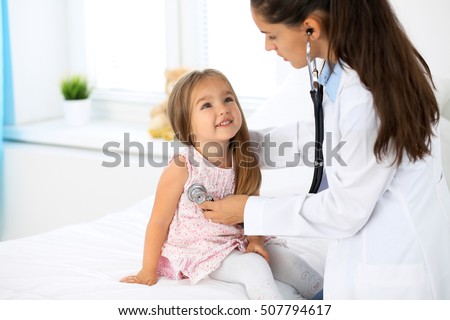 Doctor examining a little girl by stethoscope. Medicine and health care concept.