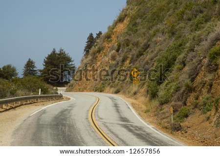 A sharp right turn on a sunny rural highway