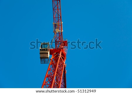 Red crane against blue sky. Copyspace.