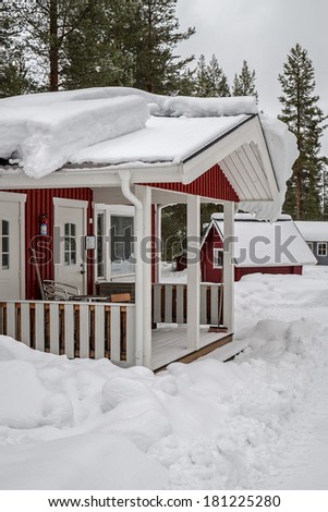 A little cabin covered with snow in Swedish Lapland