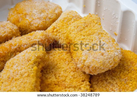 Prepackaged frozen chicken nuggets close-up shot.