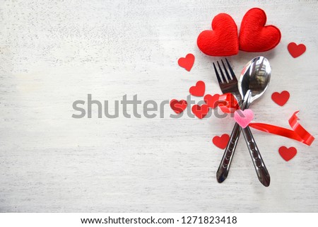 Valentines dinner romantic love food and love cooking concept - Romantic table setting decorated with fork spoon and red heart on white wooden texture background top view copy space