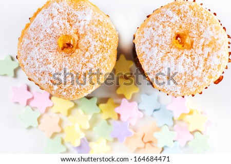 Close up cakes with small stars candyes on the white