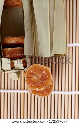 Cane sugar  in asian style packed in banana leaf on the wood mat
