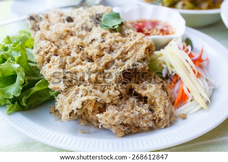crispy catfish spicy salad and sweet sauce, Thai food.