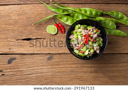 Pad Sa tor Ka pi Moo (Fired Parkia speciosa beans with Shrimp paste and pork   ) traditional Thai food from South of Thailand. beautiful thai food cuisine on  natural wooden texture background