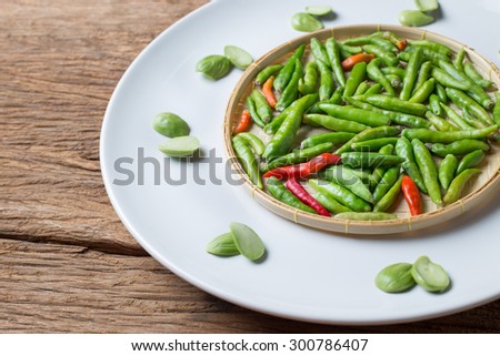 Little Thai chili spicy and Parkia speciosa sator bean on Basketry white plate ingredient for Thai Food cuisine