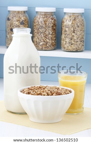 Delicious and healthy crunchy oats cereal with milk and orange juice.