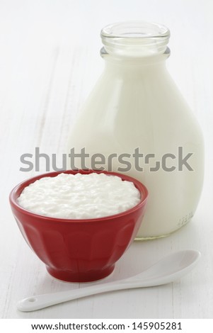 Cottage cheese and fresh milk on vintage french table linen.