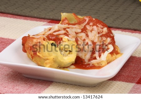 pasta gourmet shells stuffed with prosciutto and spinach and cover with tomato sauce