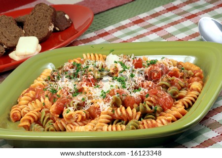 Delicious and perfect made to perfection rainbow rotelli pasta with parmesan cheese and exquisite  fresh organic tomatoes sauce vegans or vegetarians will love it