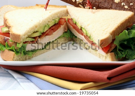 Gourmet exquisite oven roasted turkey breast sandwich with turkey bacon avocado tomato and lettuce all organic and healthy