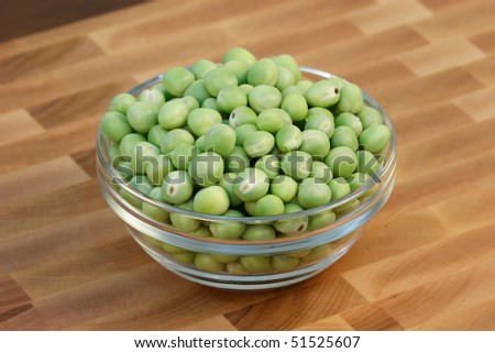 green beans  on fine wood cutting board with wood  background