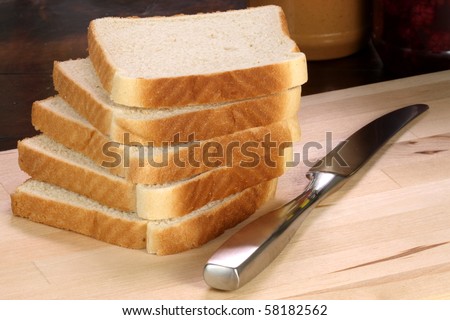 peanut butter and jelly sandwich ingredients on preparation wood board