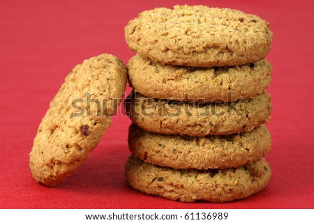Fresh baked Stack of warm oatmeal cranberry cookies on fine tablecloth made of linen, shallow DOF