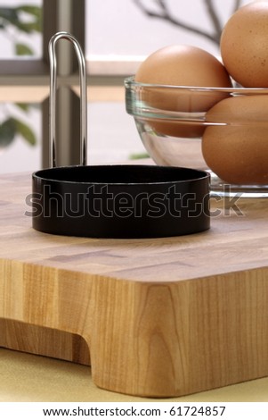 raw eggs on fancy kitchen board and egg ring