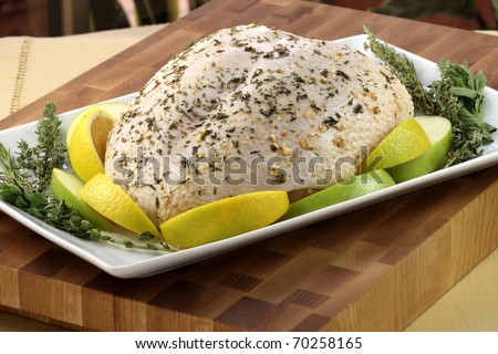 raw and juicy turkey breast seasoned with herbs, fresh and healthy food ready to go into the oven