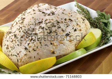 raw and juicy turkey breast seasoned with herbs, fresh and healthy food ready to go into the oven