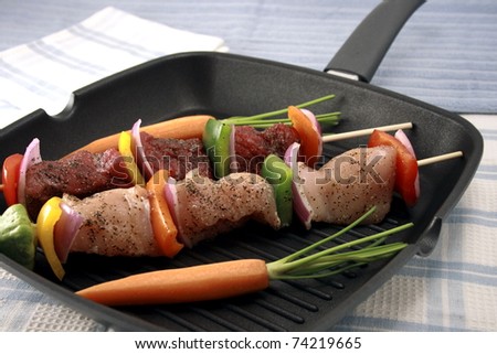 raw fresh and juicy beef tenderloin and  chicken breast skewers or shish kabobs