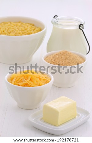 Delicious macaroni and cheese ingredients on vintage wood setting.