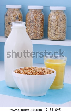 Delicious and nutritious breakfast muesli or granola cereal with milk on vintage styling.