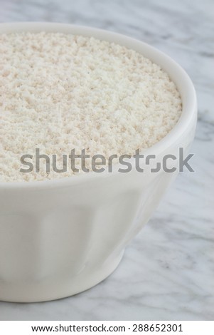 nixtamalized mexican corn flour on carrara marble pastry board