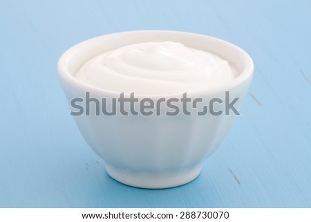 Delicious, nutritious and healthy fresh plain greek  yogurt on antique wood table