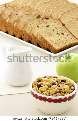 delicious breakfast with whole grain bread,fresh green apple and a healthy bowl of cereal.