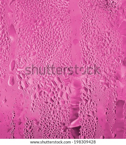 close-up of water drop on water jug in pink color for background