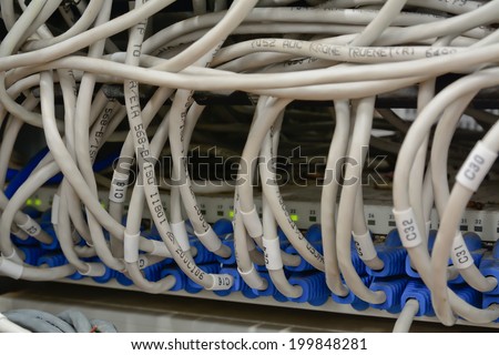 close-up of  ethernet cables connected to computer  internet server with many dust
