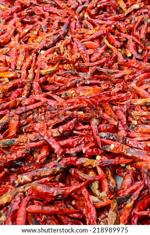 closeup of low-grade  dried red peppers ; selective focus with blur foreground and background
