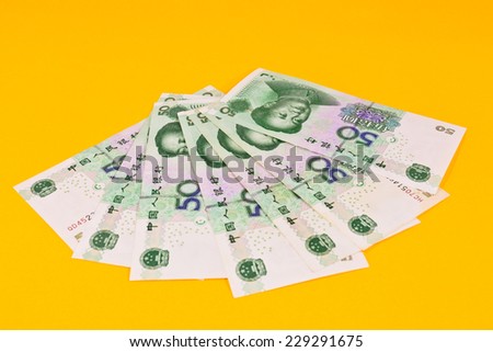 chinese money (renminbi) - 50  Yuan bank notes on yellow background . Concept photo for money, banking ,currency and foreign exchange rates