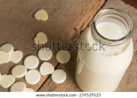 Milk in glass bottles with milk pellets Depth of Field style