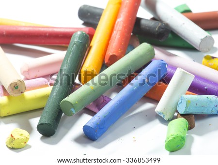 Old pastels colorful crayons on white background