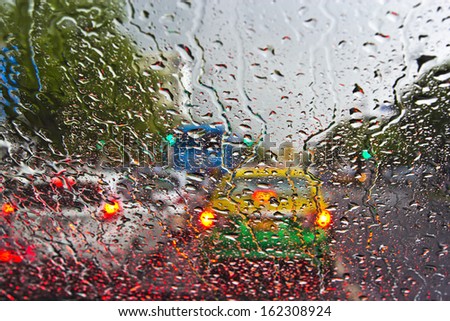 Raindrops on window. Blurred cityscape on a background.