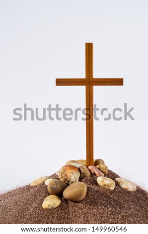 Cross on a hill Wooden cross on a hill with some stones