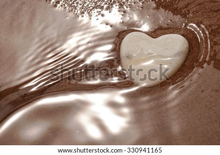White heart on a beach with amazing wonderful waves and beautiful shiny water/ Heartbeat waves/Heart on the beach