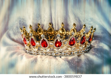 Beautiful jewel crown with ruby and diamond stones on velvet with color and blur effects/Jewelry crown/decoration item