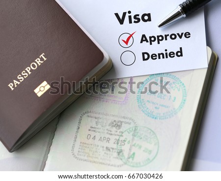 Visa and passport to  approved stamped on a document top view in Immigration