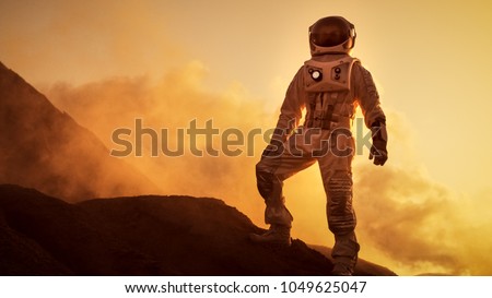 Silhouette of the Astronaut Standing on the Rocky Mountain of the Alien Red Planet/ Mars. First Manned Mission on Mars. Space Exploration, Colonization.