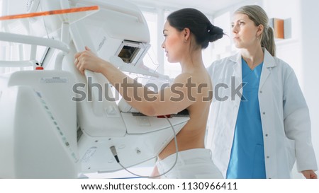 In the Hospital, Portrait Shot of Topless Female Patient Undergoing Mammogram Screening Procedure. Healthy Young Female Does Cancer Preventive Mammography Scan. Modern Hospital with High Tech Machines