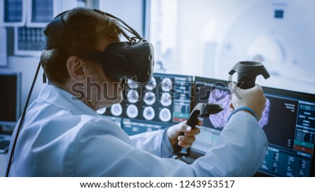 Futuristic Concept: In Medical Laboratory Surgeon Wearing Virtual Reality Headset Uses Controllers to Remotely Operate Patient with Medical Robot. High-Tech Advancements in Medicine.