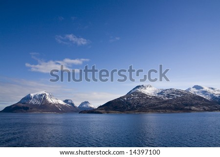Snow-covered mountains at the Arctic ocean