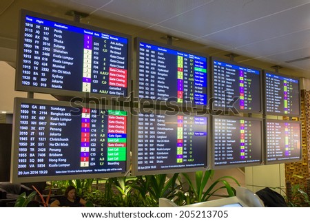 SINGAPORE - JUNE 20: Departure information monitors at Changi Airport, Singapore on June 20, 2014. Singapore airport is the main aviation hub in South East Asia.