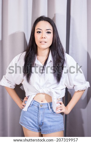 Portrait of beautiful young woman looking with easy attractive smile - indoors