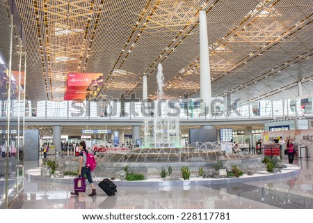 BEIJING - AUGUST 30: Passengers at railway station, Beijing Capital Airport Terminal 3 on August 30, 2014. The world\'s largest airport terminal-building complex measures 986,000 m2 floor surface.