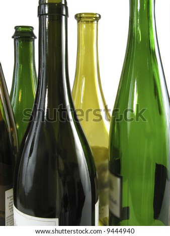 Collection of empty wine bottles, shades of green.